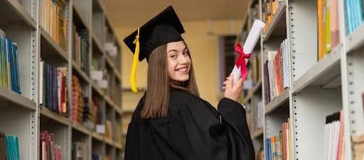 a happy school graduating gifted student in the library