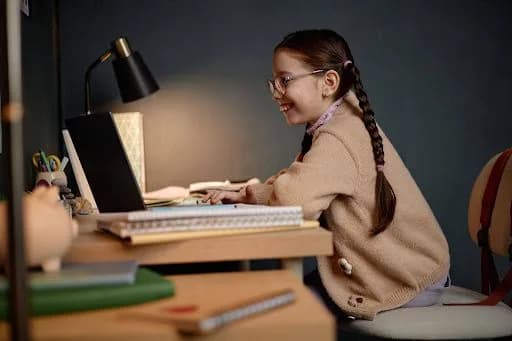 a happy girl studying online